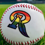 A baseball with a rainbow-hued letter R on it