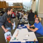 Andrew talks with a student at the RIT Community Service Fair.